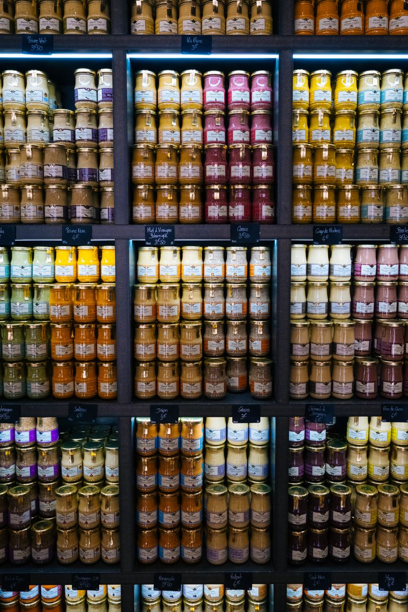 Shelf of different types of mustard jars