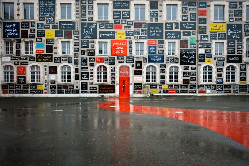 Building with several sign with text hung on the facade