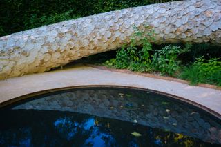 Snake statue near a pond in a park