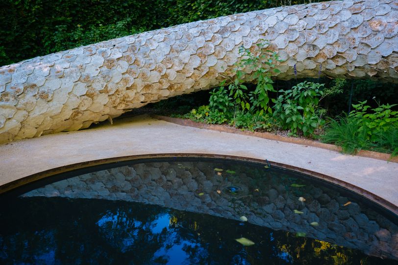 Snake statue near a pond in a park