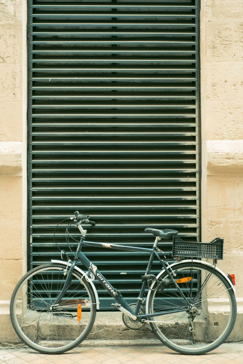 A bicycle parked in front of a ventilation
