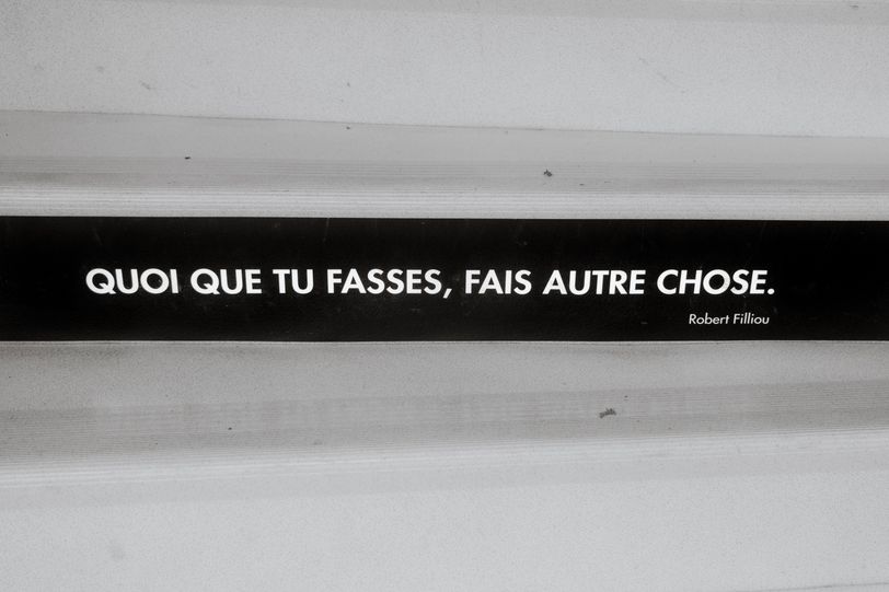 A quote written on stairs saying "whatever you're doing, do something else"