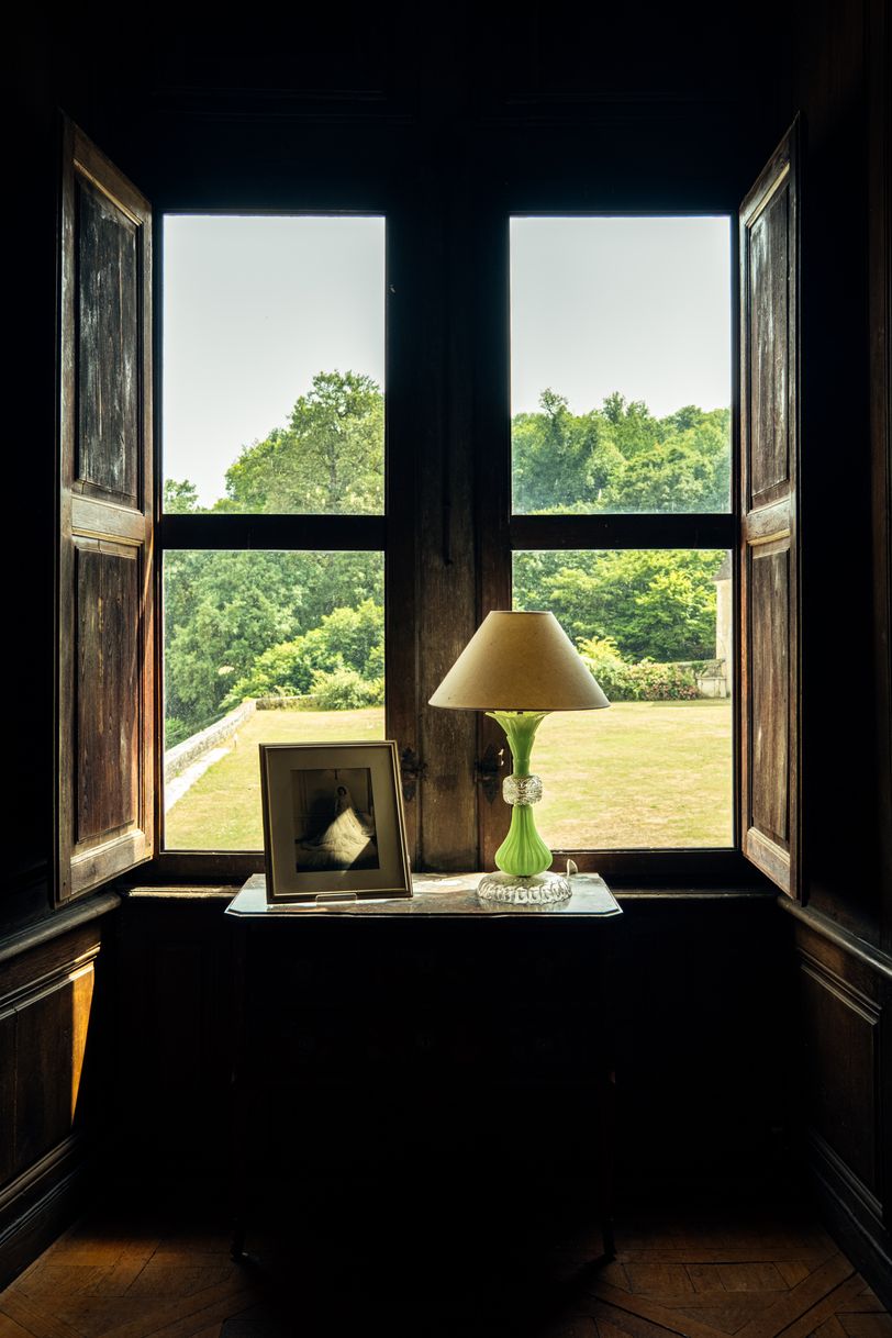 View of a park through a window from inside an old house