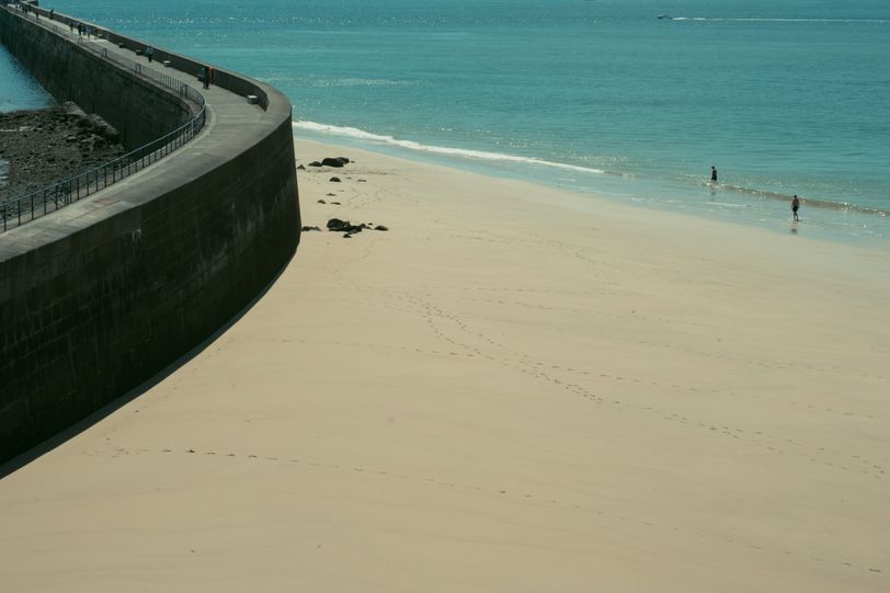 View on an empty beach separated by a dam