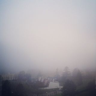 View of a town surrounded by fog