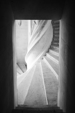 Door with stairs leading to spiral stairs