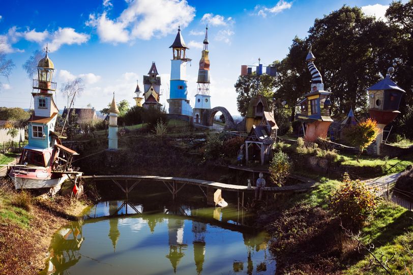 Landscape of sculptures in a garden representing unsteady houses
