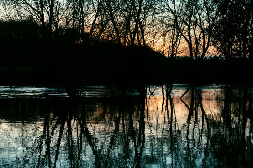 An overflowing river on sunset