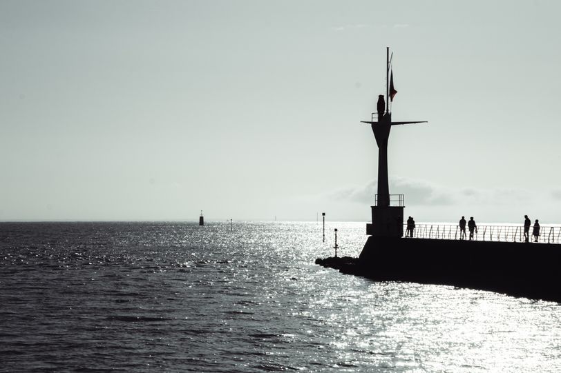 View on the sea and a bit of land where a lighthouse stands