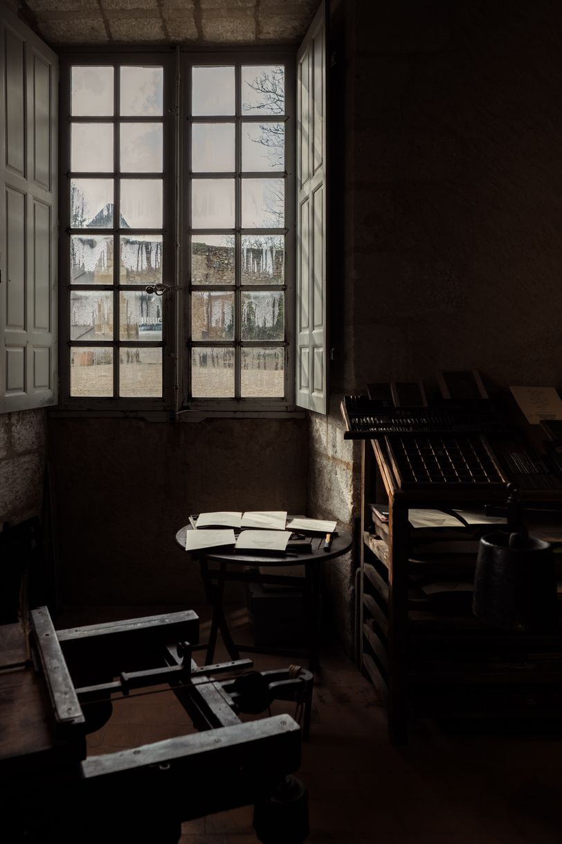 An old printer workshop only lit by a big window
