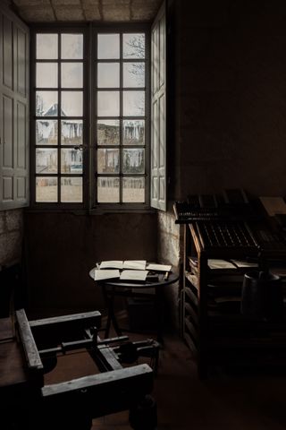 An old printer workshop only lit by a big window