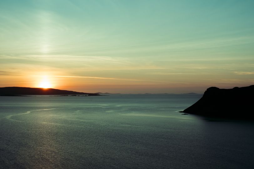 View of a setting sun over the sea in the Skye islands