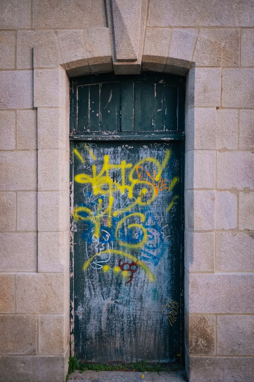 Tagged door in a bad condition of a clean and renovated building