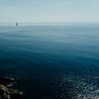 Seascape with shores, waves, a lighthouse and nothing in each corner