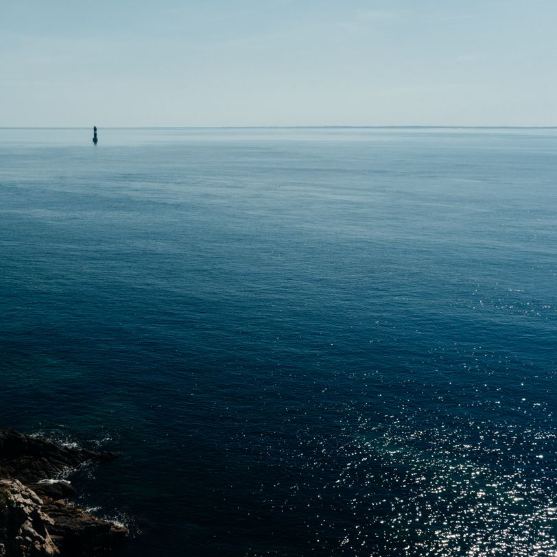 Seascape with shores, waves, a lighthouse and nothing in each corner